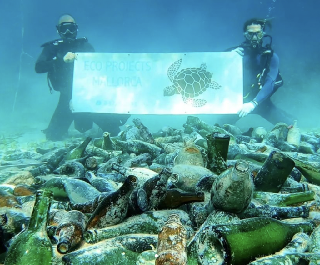 Divers recover discarded champagne bottles from the seabed